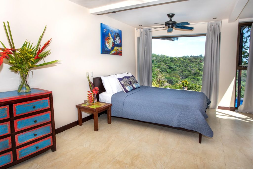 This very private colorful queen bedroom is accessed directly from the pool deck.