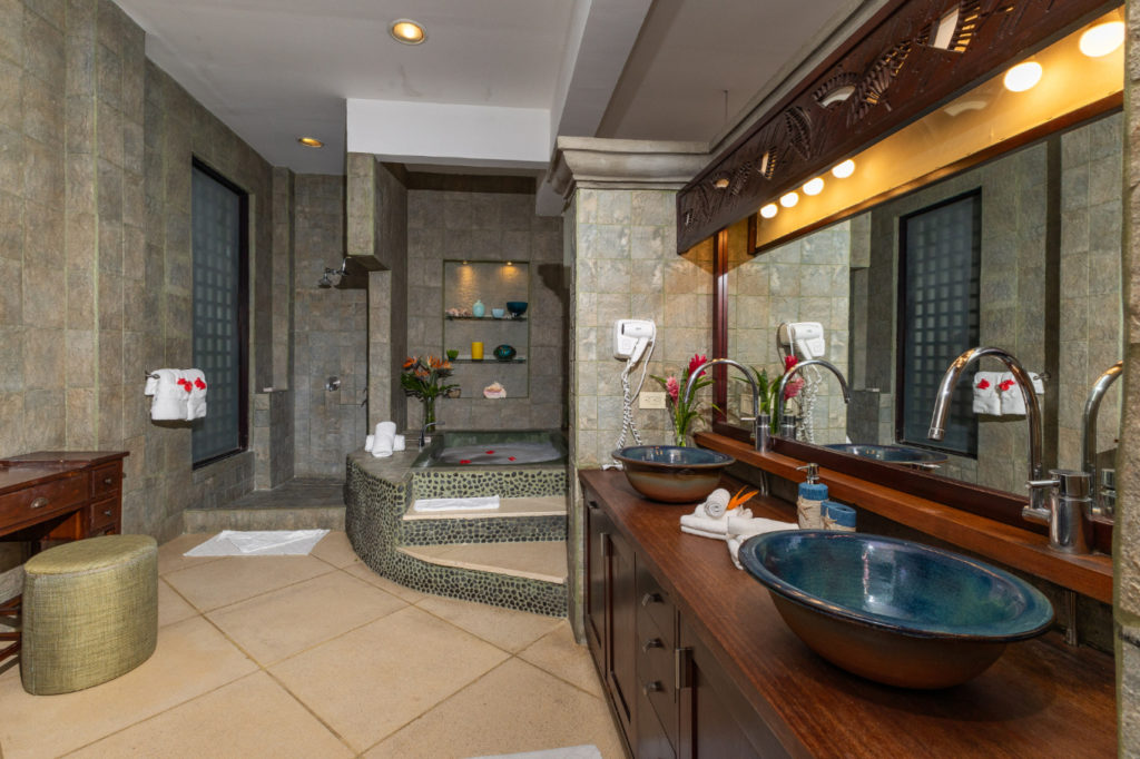 Pamper yourself in this spacious, elegant bathroom, equipped with all the amenities for ultimate luxury, including a bathtub, double sinks, and a generous shower space.