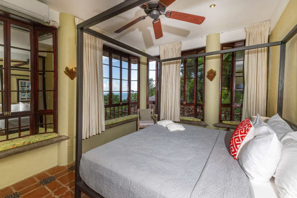 Each bedroom in this stunning villa boasts a king-size bed, complete with full air-conditioning and breathtaking views of both the jungle and the ocean.