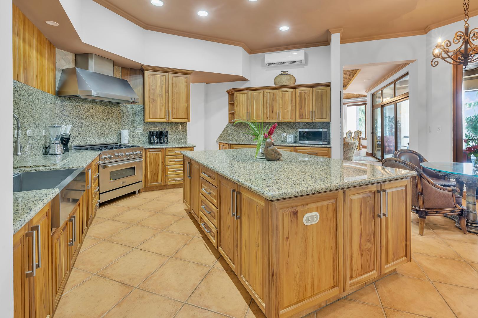 Gourmet kitchen with large island at a luxury beachfront vacation villa in Playa Tambor, Costa Rica.
