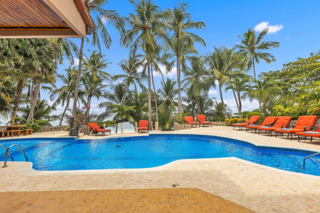 The expansive pool terrace overlooks Playa Tambor, offering a relaxing place to swim, sunbathe, and enjoy Costa Rica's beautiful Pacific coastline.