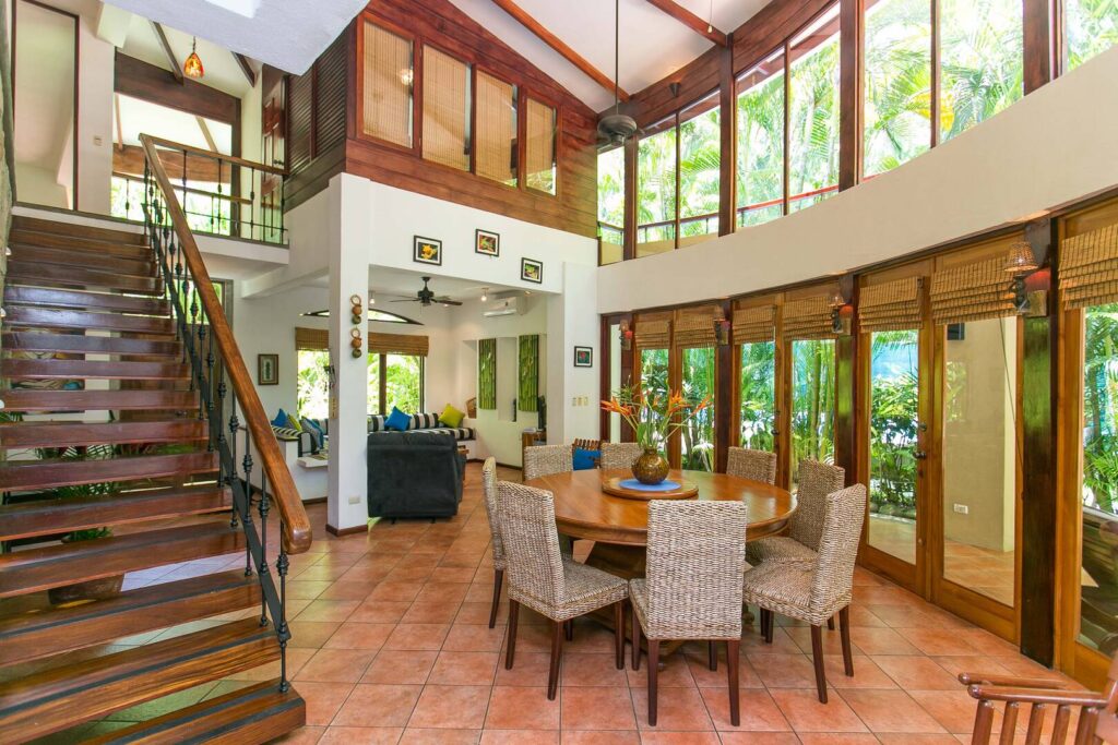 The dining table is the central feature here, surrounded by a view of lush jungle.