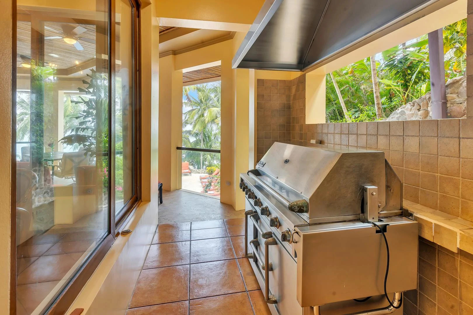 Covered outdoor BBQ kitchen at a luxury beachfront vacation villa in Playa Tambor, Costa Rica.