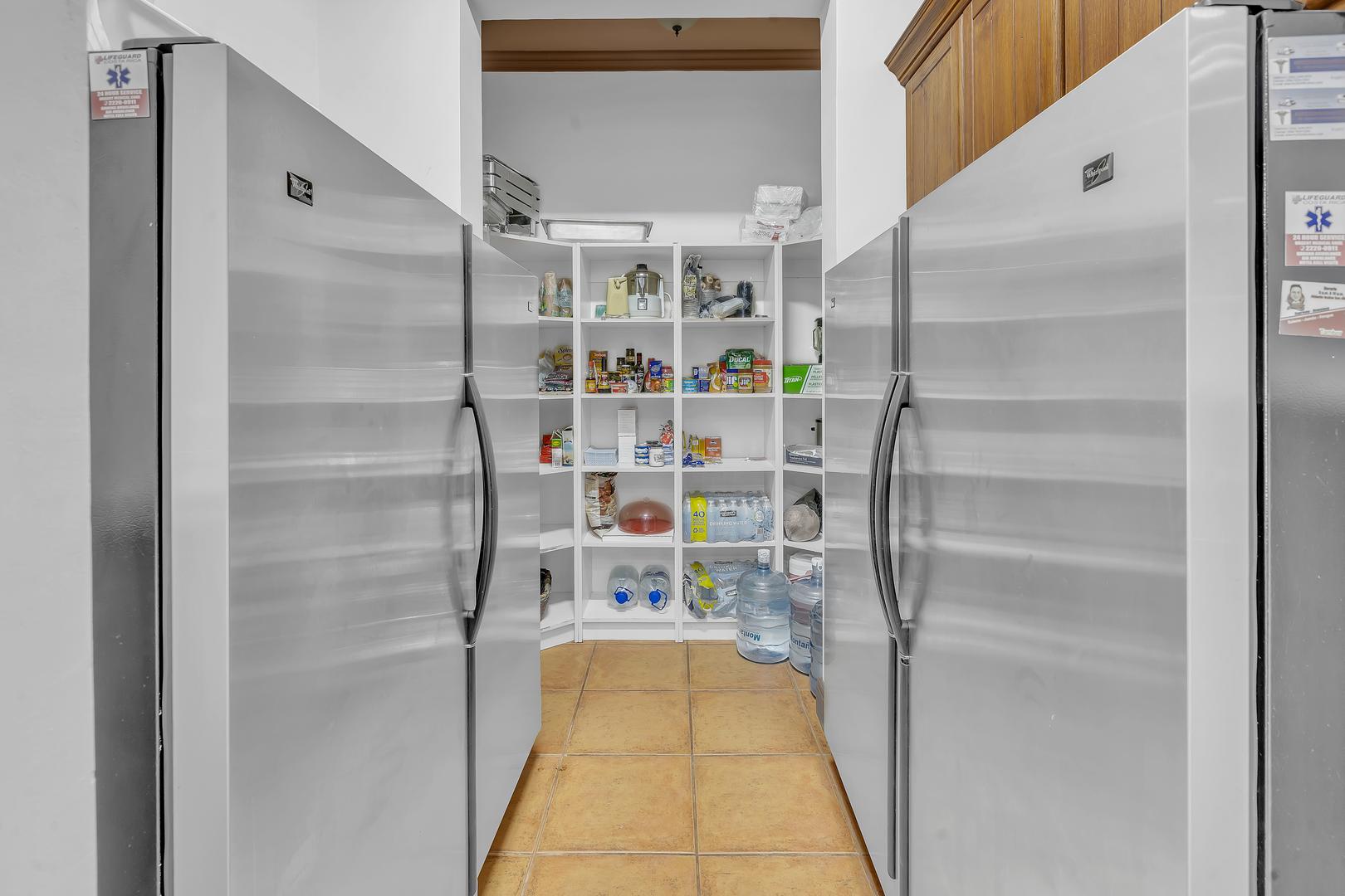 Walk-in pantry with multiple refrigerators at a luxury beachfront vacation villa in Playa Tambor, Costa Rica.