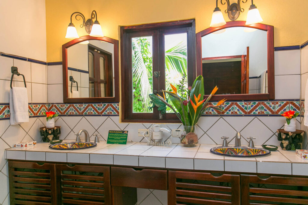 Beautifully-designed bathroom with colorful hand-painted his and hers sinks and tiles.