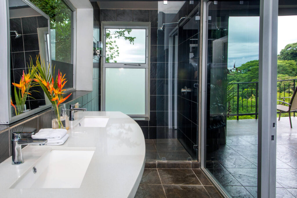 The beautiful counters and tiles in this bathroom give it a truly luxurious vibe.