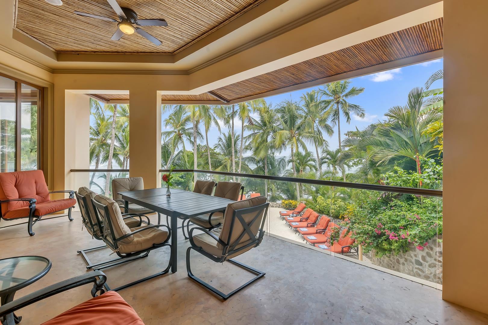 Covered ocean-view terrace overlooking the pool and beach at a luxury vacation villa in Playa Tambor, Costa Rica.