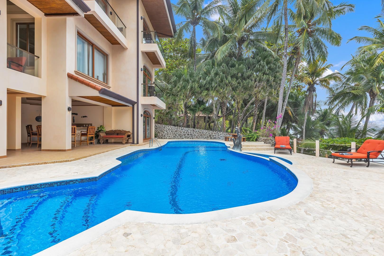 Private swimming pool with direct beach access at a luxury beachfront vacation villa in Playa Tambor, Costa Rica.