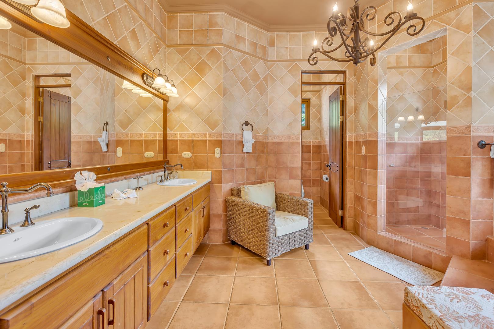 Master ensuite bathroom with double vanity and walk-in shower at a luxury beachfront vacation villa in Playa Tambor, Costa Rica.