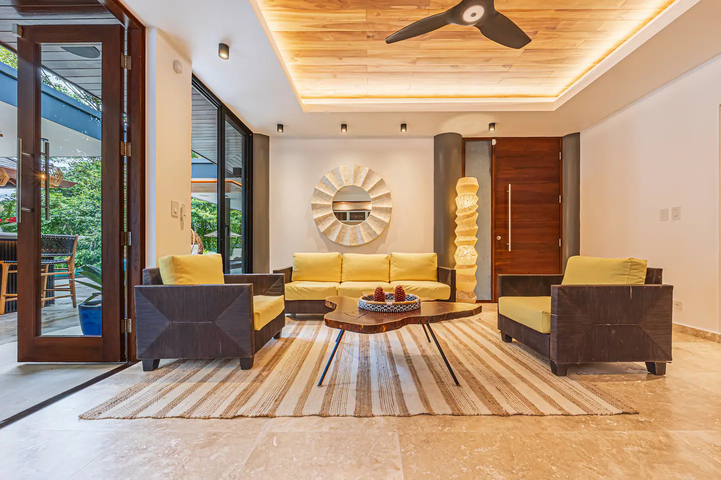 Modern living room with seating area and views of tropical jungle near Dominical, Costa Rica.