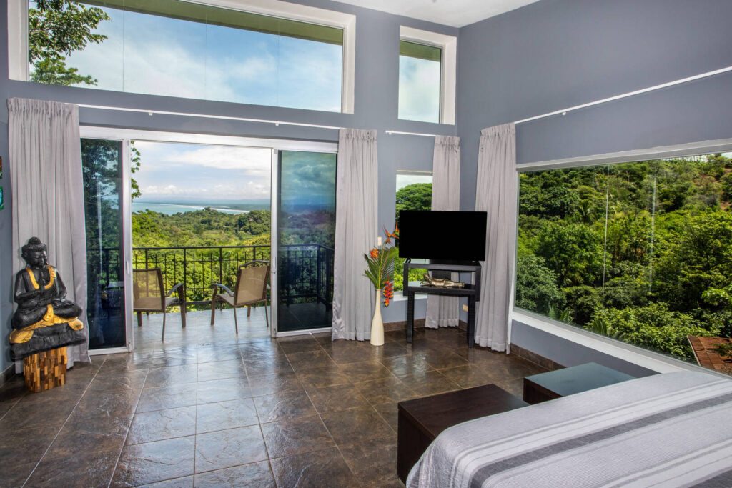 The high ceilings and extra windows at the top of this bedroom let in the most natural light possible.