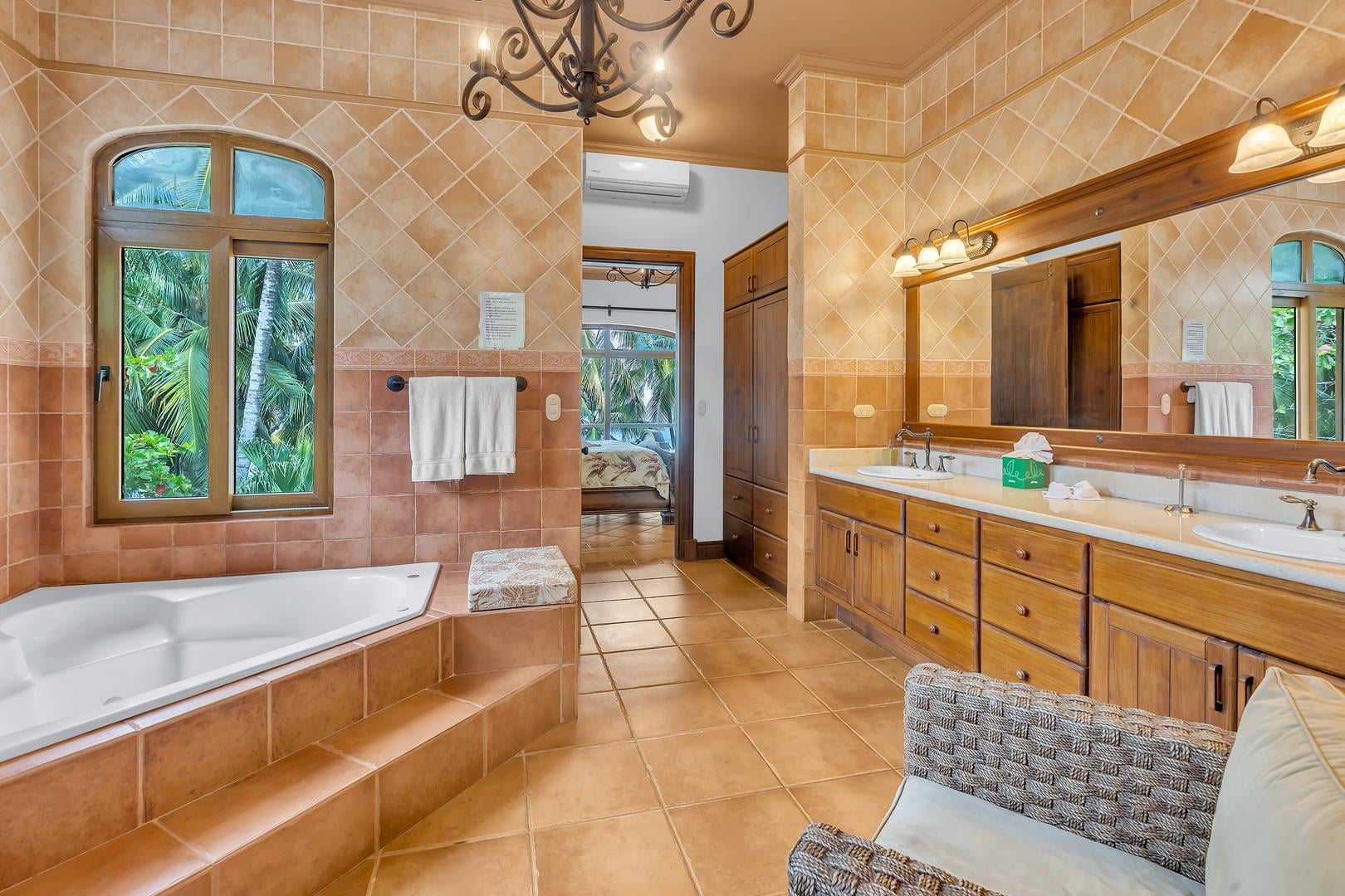 Luxury master bathroom with soaking tub and double vanity at a beachfront vacation villa in Playa Tambor, Costa Rica.
