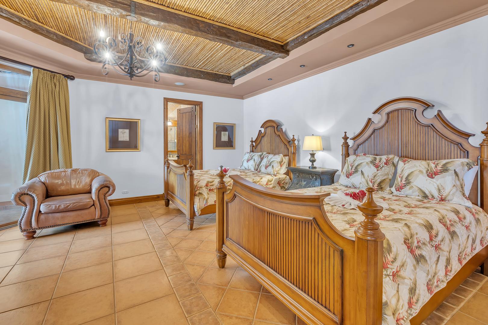 Guest bedroom with two queen beds at a luxury beachfront vacation villa in Playa Tambor, Costa Rica.