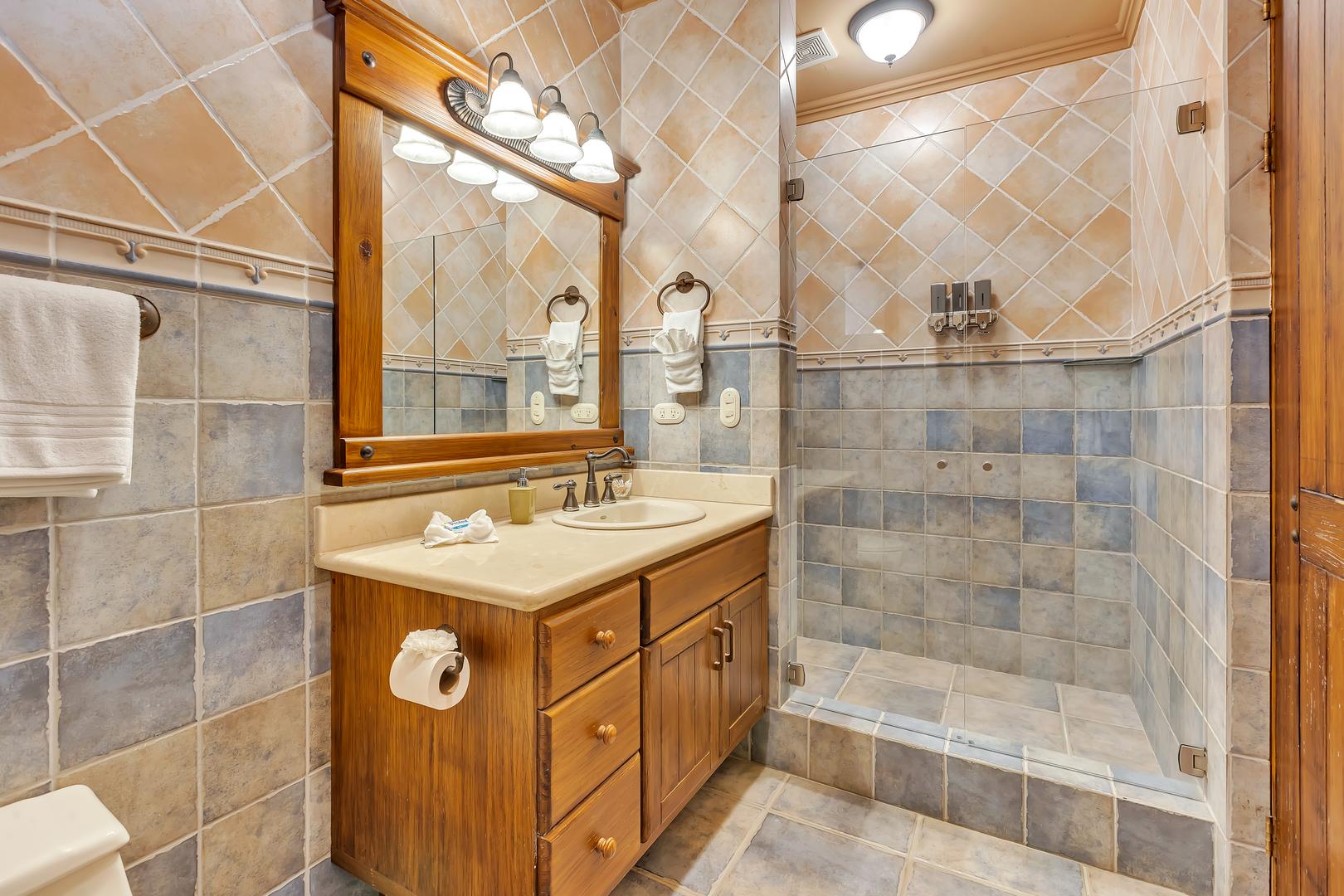 Ensuite bathroom with walk-in rain shower at a luxury beachfront vacation villa in Playa Tambor, Costa Rica.