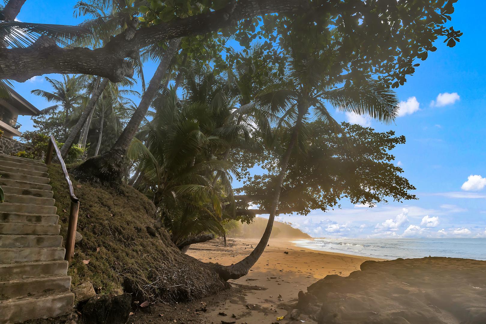 Private beach access path leading from a luxury beachfront vacation villa to Playa Tambor, Costa Rica.