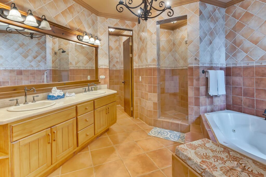The spacious ensuite bathroom features a soaking tub, walk-in shower, and double vanity for a comfortable and relaxing stay.