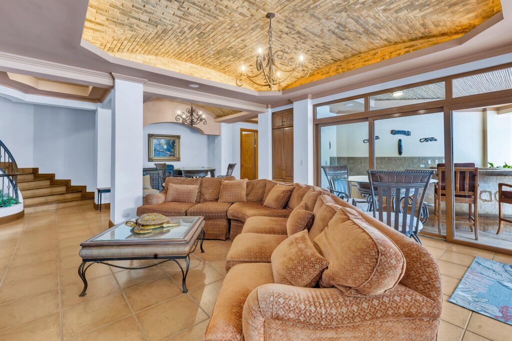 The spacious lower-level lounge connects seamlessly to a covered outdoor living area, creating the perfect place for family gatherings and relaxed evenings together.