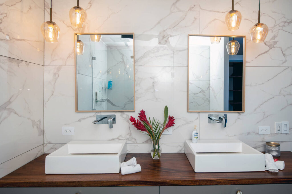 Luxury fittings, sinks, and tiles in this beautifully-decorated bathroom.