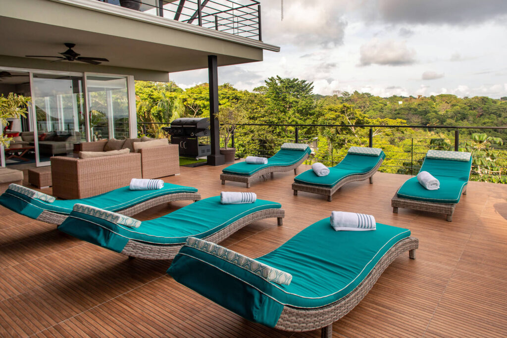 Relax on this gorgeous wooden sun deck on luxury loungers which seem to mimic the shape of the waves in the distance.