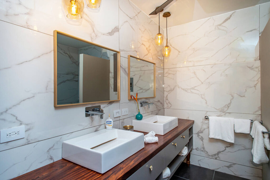 This beautiful ensuite bathroom with his and hers sinks is a lovely space to freshen up after an adventure-filled day.