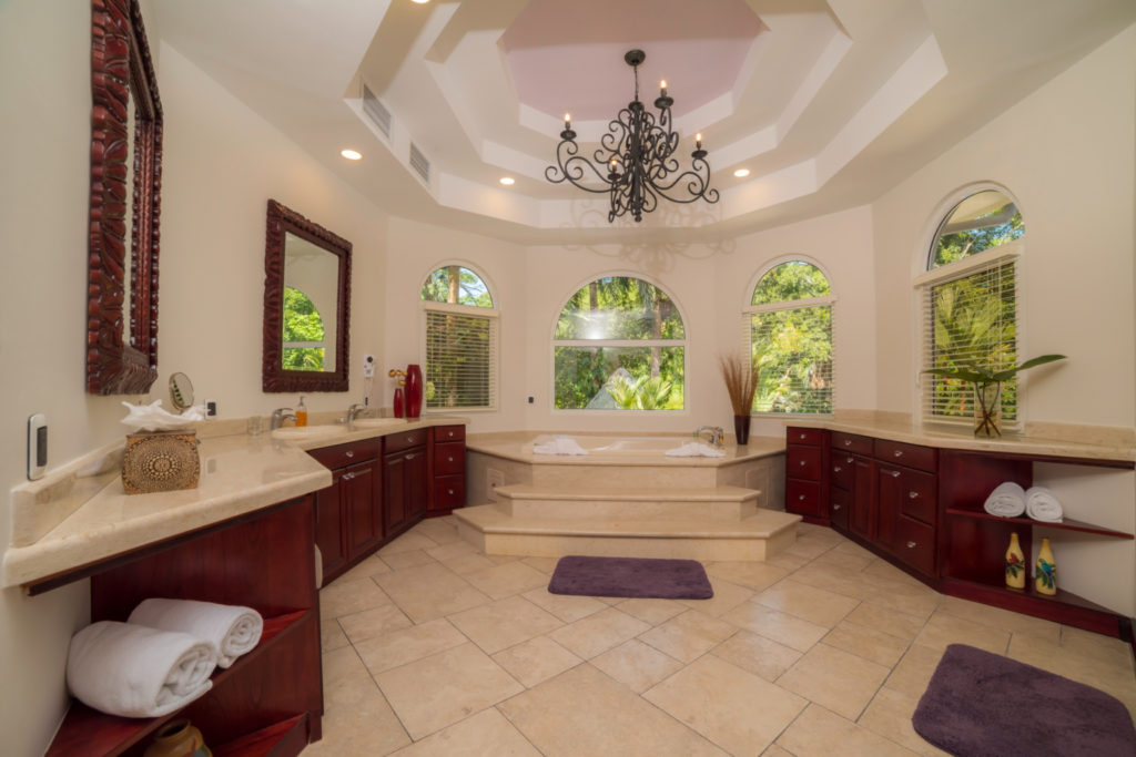 Luxuriate in our elegant bathroom oasis, where natural light spills in, illuminating an inviting bathtub. 