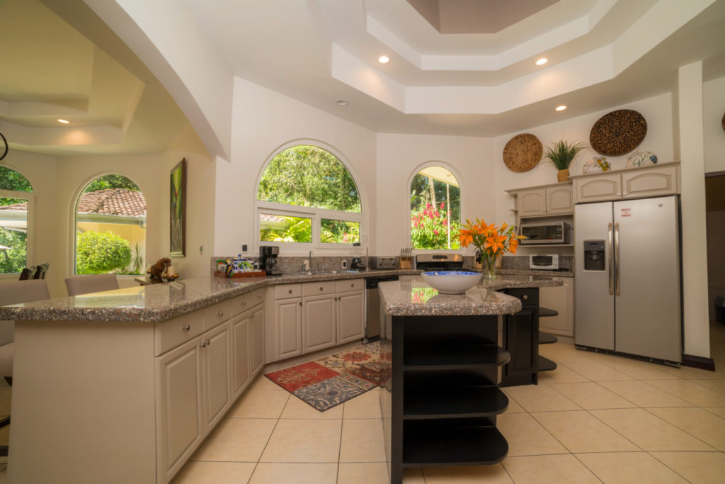 Fully equipped kitchen with abundant sunlight.