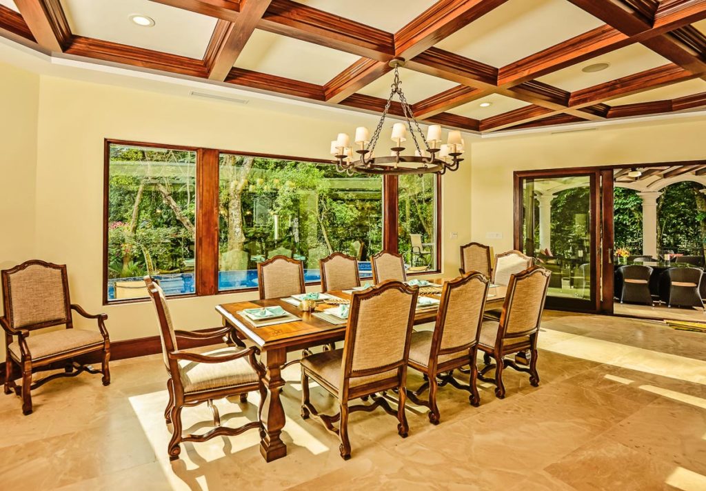 Dining in the embrace of elegance and nature. Sunlight streams into our beautiful dining room, offering a view of the pool area and lush gardens, setting the scene for unforgettable moments.