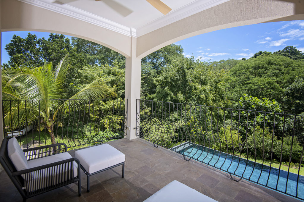 Elevated relaxation: Enjoy pool and rainforest views from your master bedroom terrace.