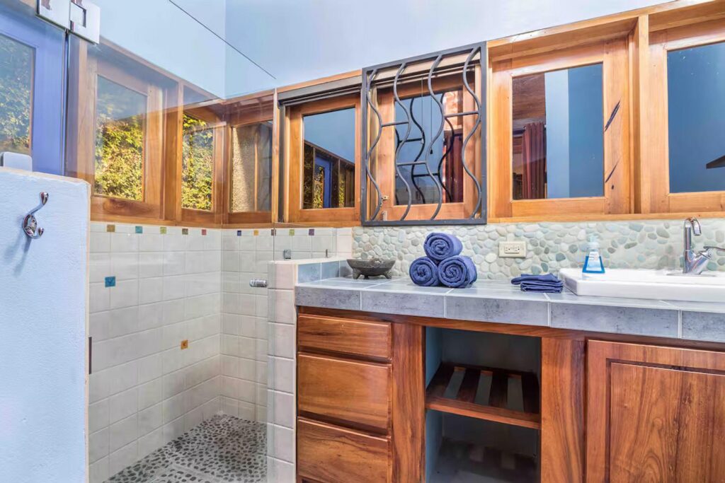 Natural stone and woodwork adorn this beautiful bathroom.