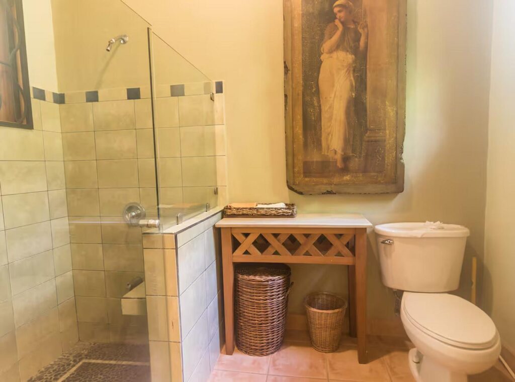 This ensuite bathroom features a large glass-door shower.
