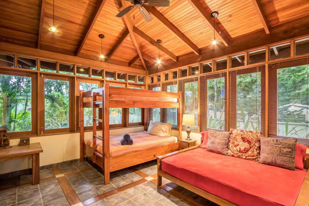 Surrounded by lush tropical garden views, this bedroom has two queen beds and a single.