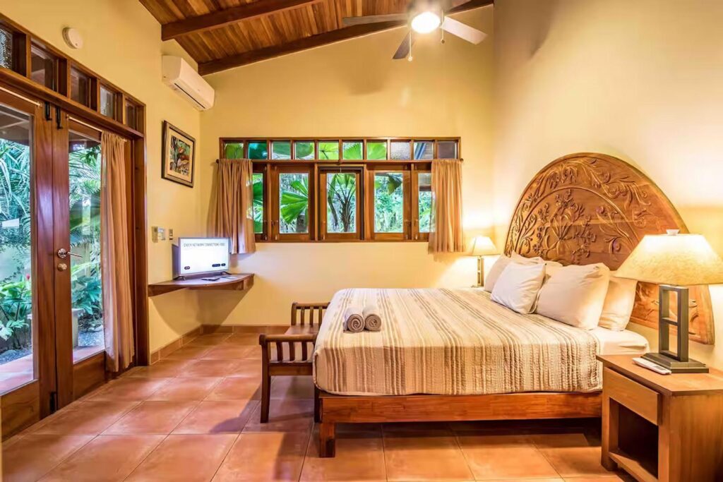 This opulent yet simple bedroom has large glass doors which can open up to let the ocean air flow through.