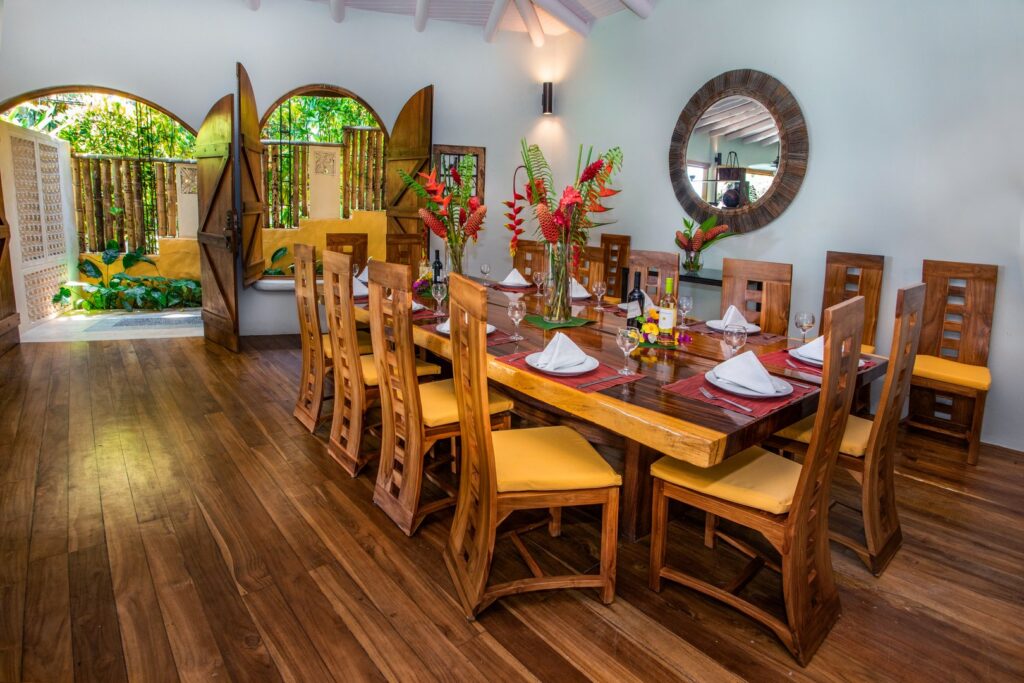 The massive custom-made dining table is located near the front entrance to the villa.