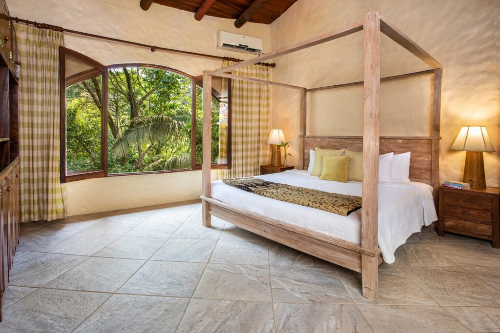 Rest on this king poster bed with open windows allowing the sights and sounds of the rainforest into the room.