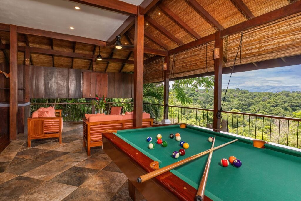 The games room on the third level features a regulation pool table, smart TV, and plenty of luxury seating.