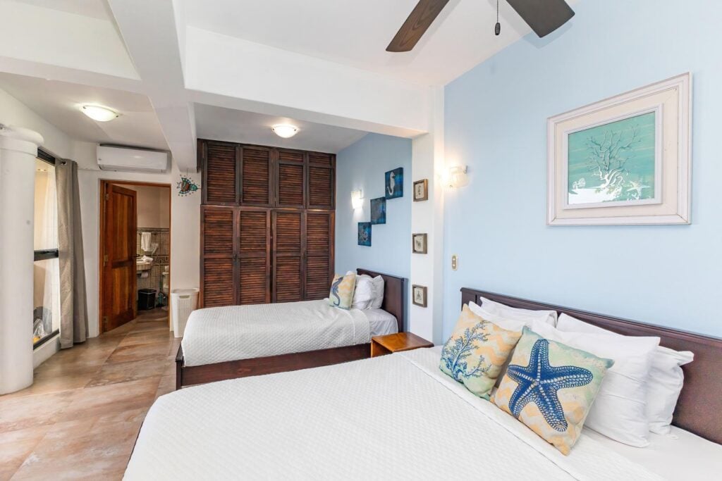 A bright twin bedroom with soft coastal tones, creating a relaxed and comfortable space that’s easy to settle into.