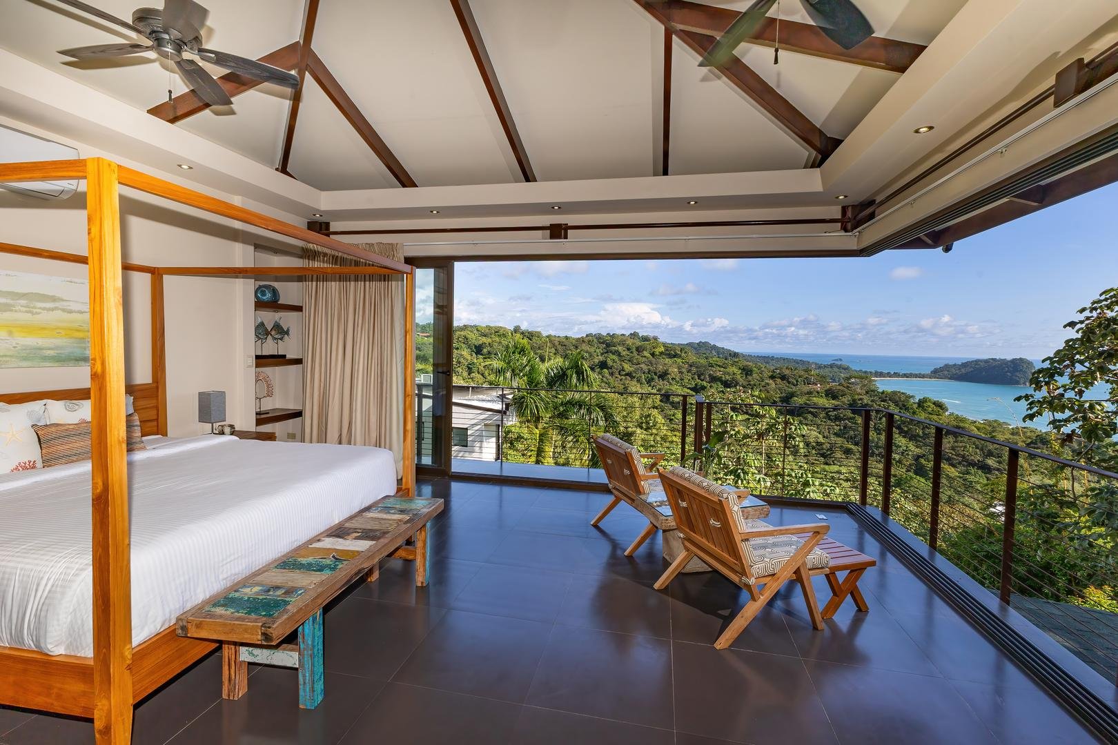 Bedroom with large windows overlooking jungle and ocean views in Manuel Antonio
