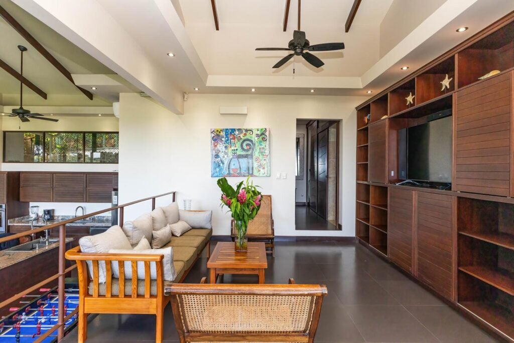 A relaxed upper-level entertainment lounge that offers a comfortable space for movie nights, downtime, or spending time together indoors.