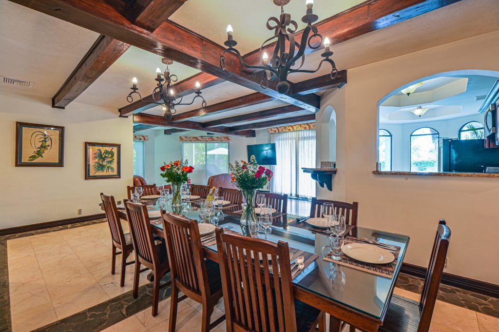 Elegant and spacious, the dining room accommodates ten guests around a gorgeous wood table.