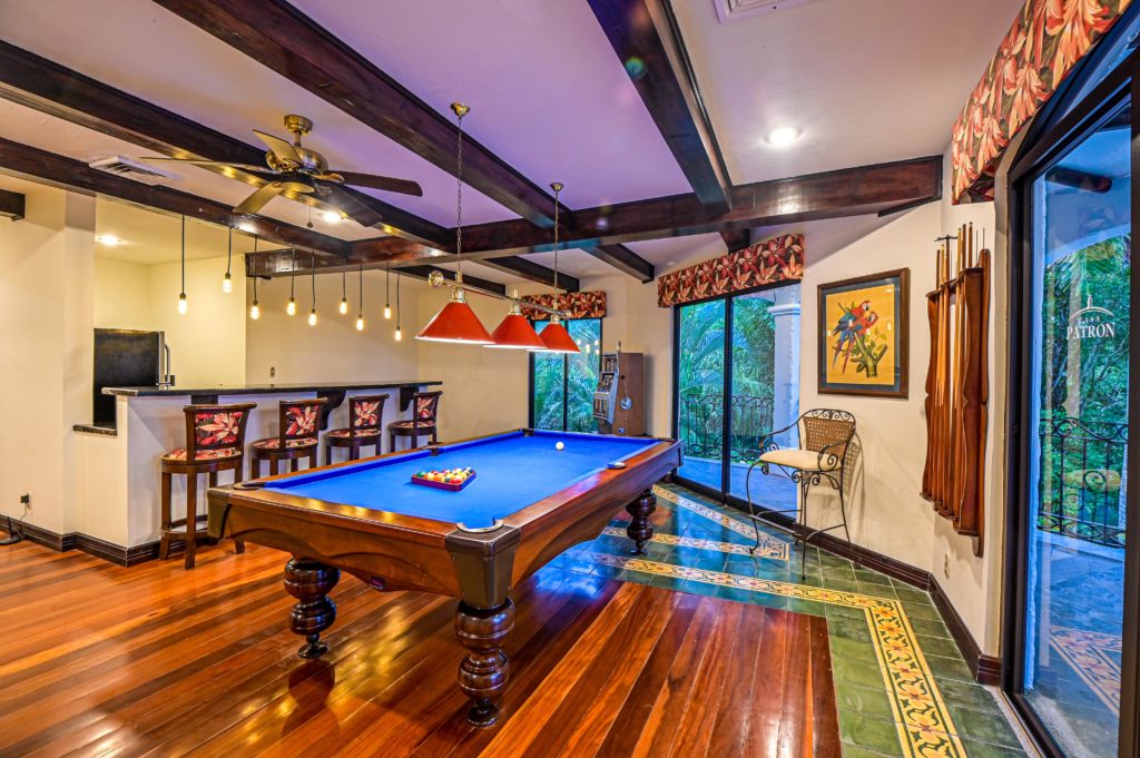 The open design game room offers a picturesque view of the lush exotic gardens.