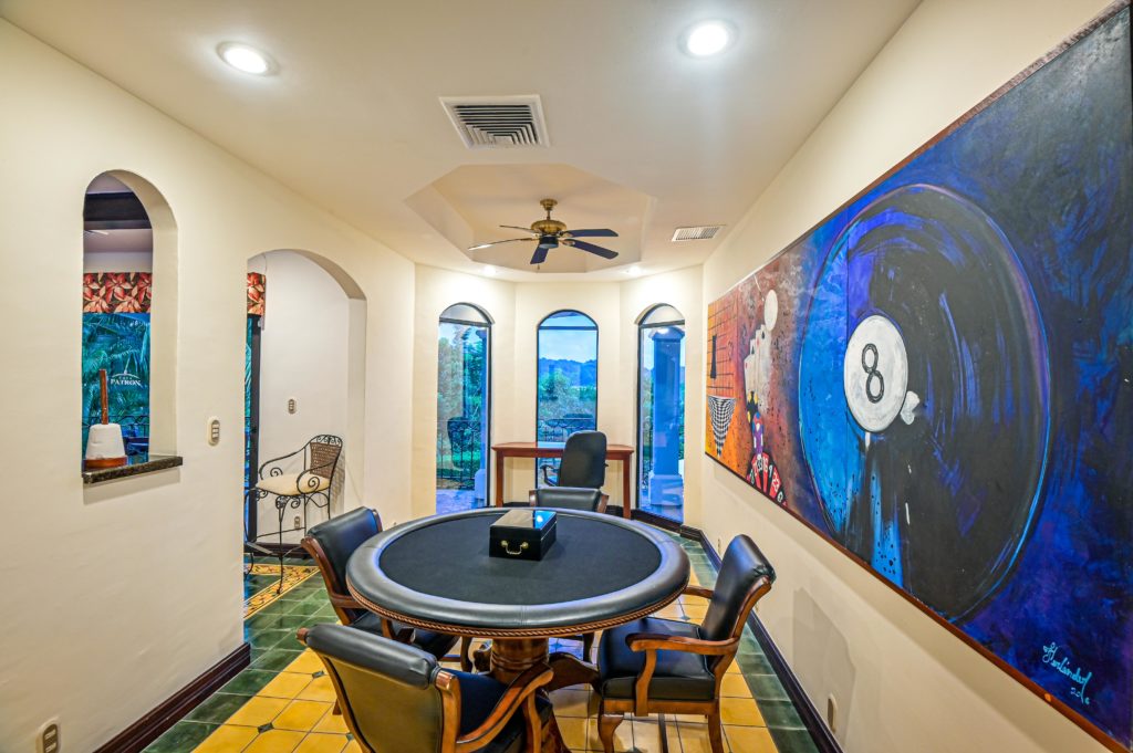 This splendid game room offers a space with a professional poker table.