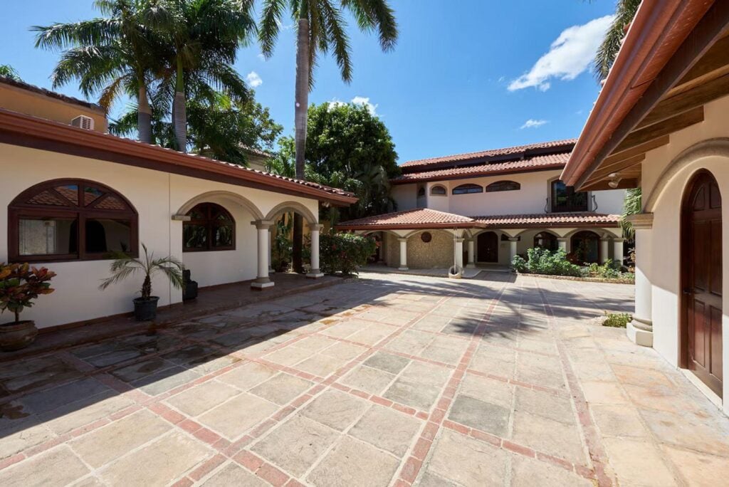 The front courtyard offers plenty of parking space. To the left is the charming private casita, perhaps for a separate family within your group.