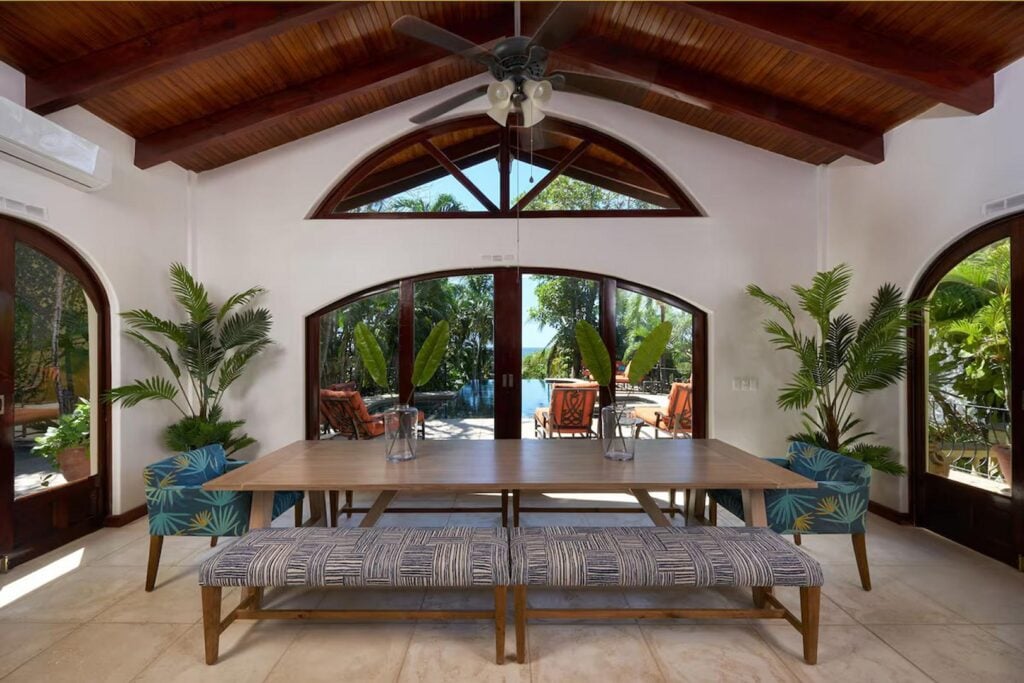 The dining area overlooking the pool has seating for your whole family to enjoy lunch or dinner together.