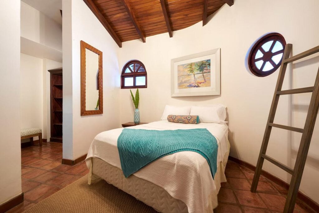 This unique guest bedroom offers a comfortable queen bed with luxurious linens.