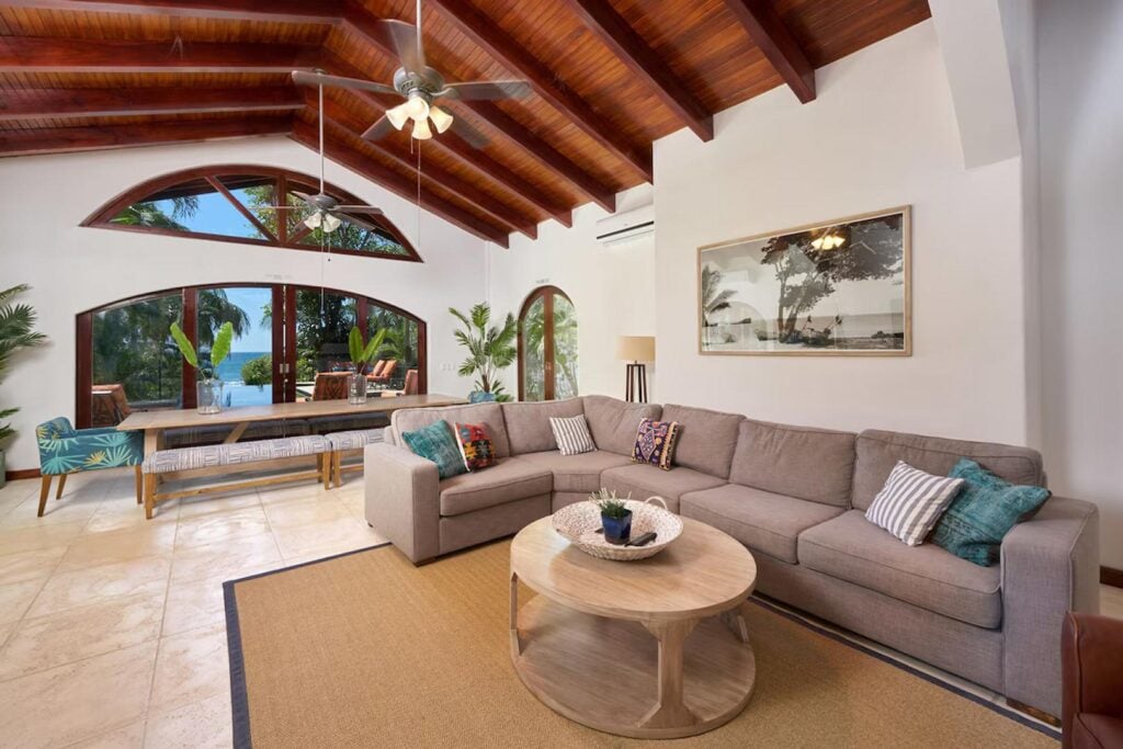 The airy living space and pool area merge by opening the large sliding doors, and a Sonos sound system and smart TV provide entertainment.