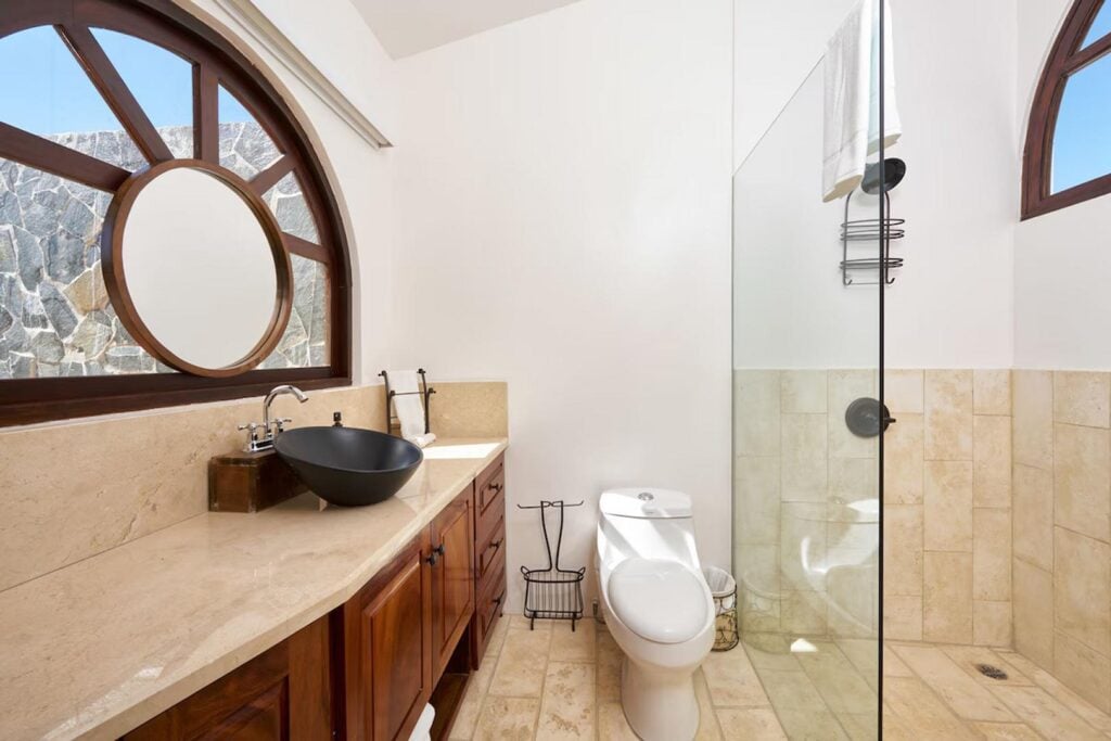 The simple clean design of this second master bathroom is filled with natural light.