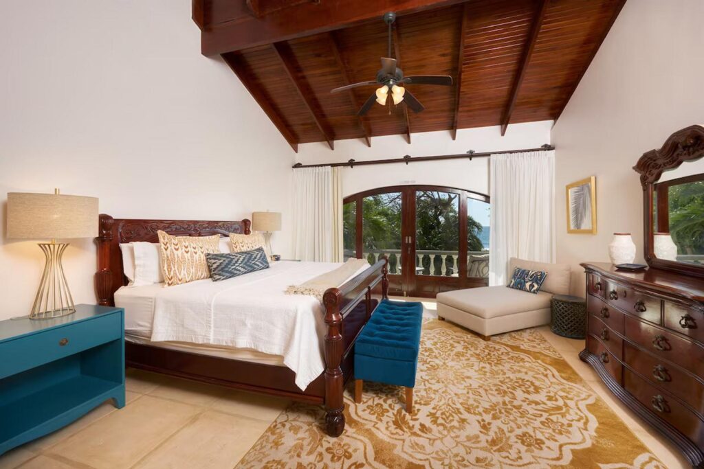 Get a full night of good rest in your master bedroom with a hand-carved king bed and an ocean-view balcony. 