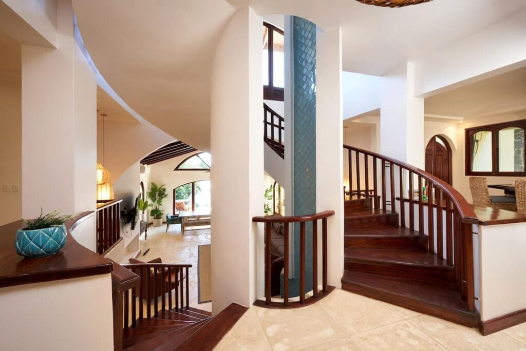 The beautifully-designed villa centers around a tiled waterfall spanning three stories in the middle of the impressive spiral staircase.