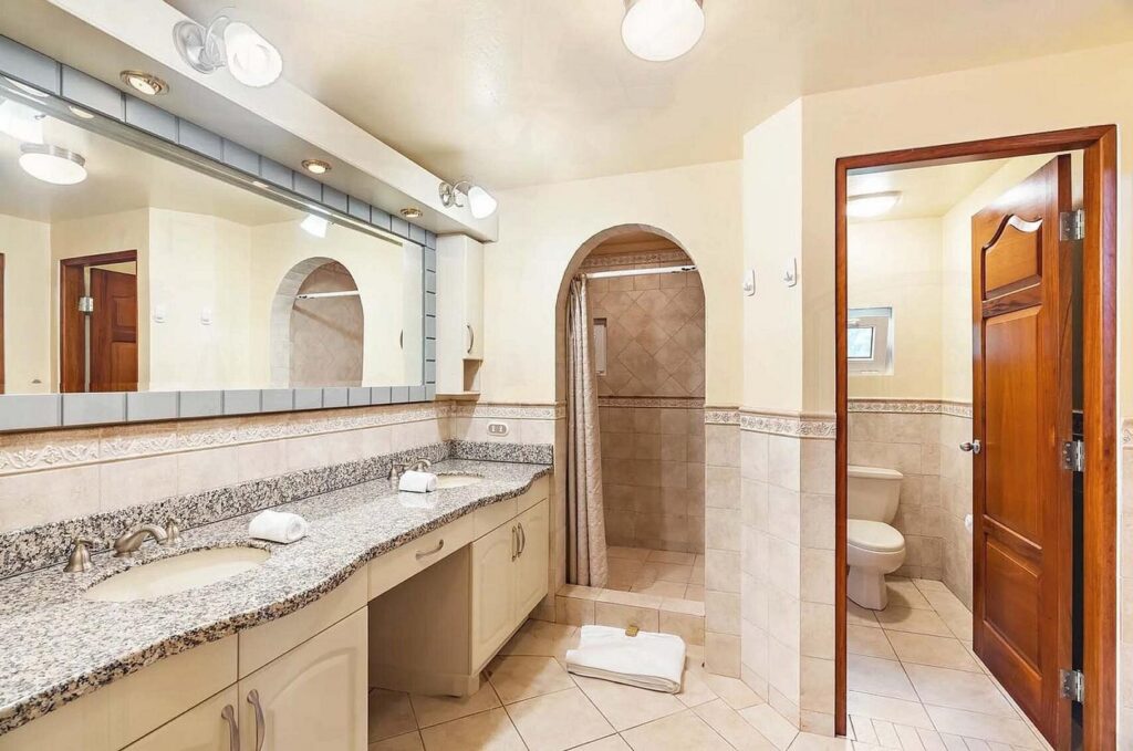 A well lit bathroom  and beautifully designed, leads into the bedroom