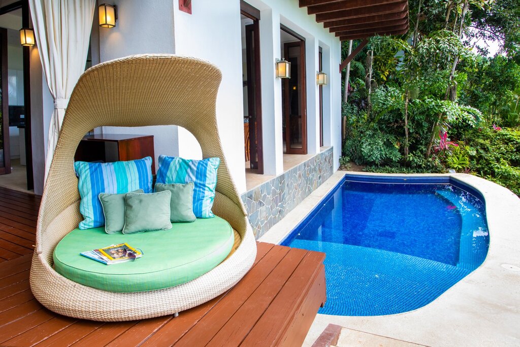 This lounging chair is the perfect place to read a book or just relax by the pristine pool. 